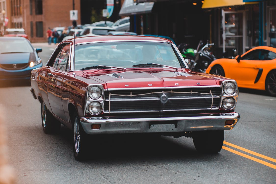 A red car driving on the road.