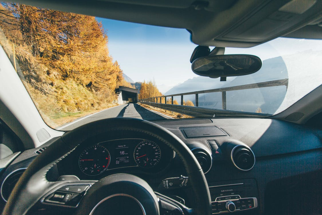 vehicle on road trees mountains